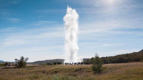 A geyser erupting on a sunny day - Golden Circle and Reykjavík Break