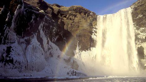 Rainbow over a waterfall on the The Golden Circle and South Shore tour